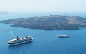 the volcanic islets of Christina and Nea and Palia Kammeni with two cruise ships in the water in front
